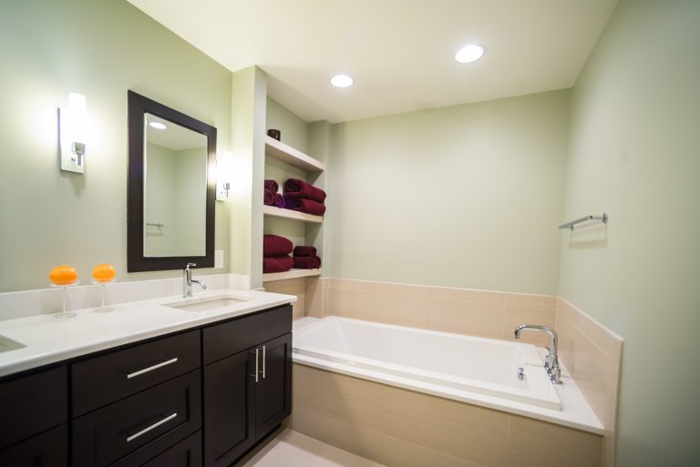 sleek modern bathroom neutral colors sage green separate tub