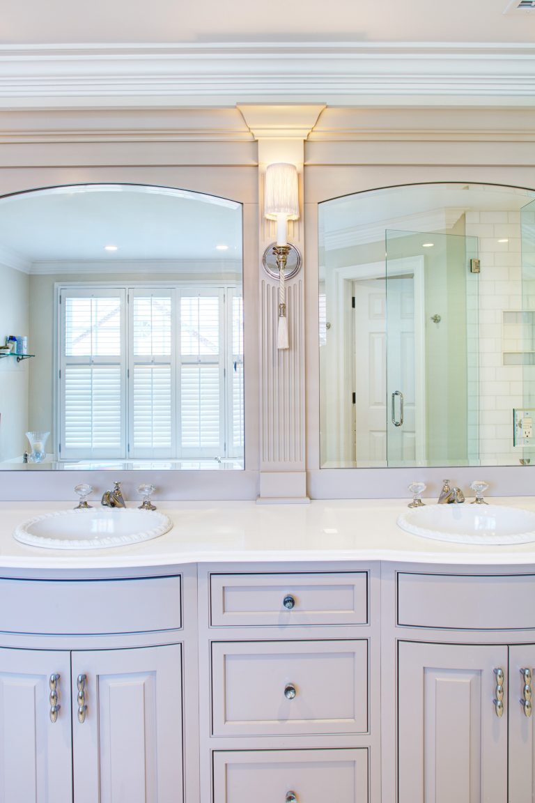 traditional style bathroom remodel white cabinetry double sink vanity large mirrors sconce lighting