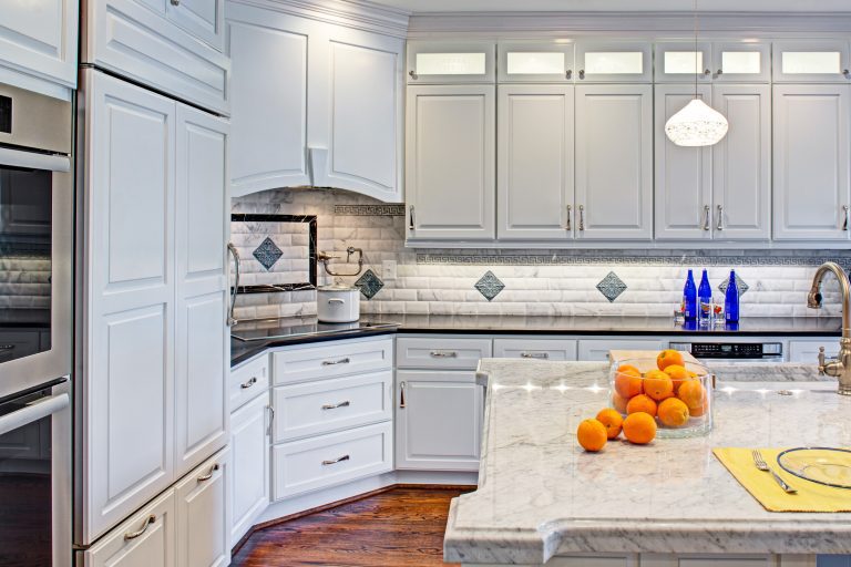 bright white kitchen tile backsplash with detail island double wall oven frosted glass upper cabinetse