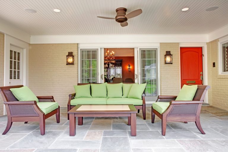 spacious and inviting front porch with ceiling fan neutral palette with pop of color
