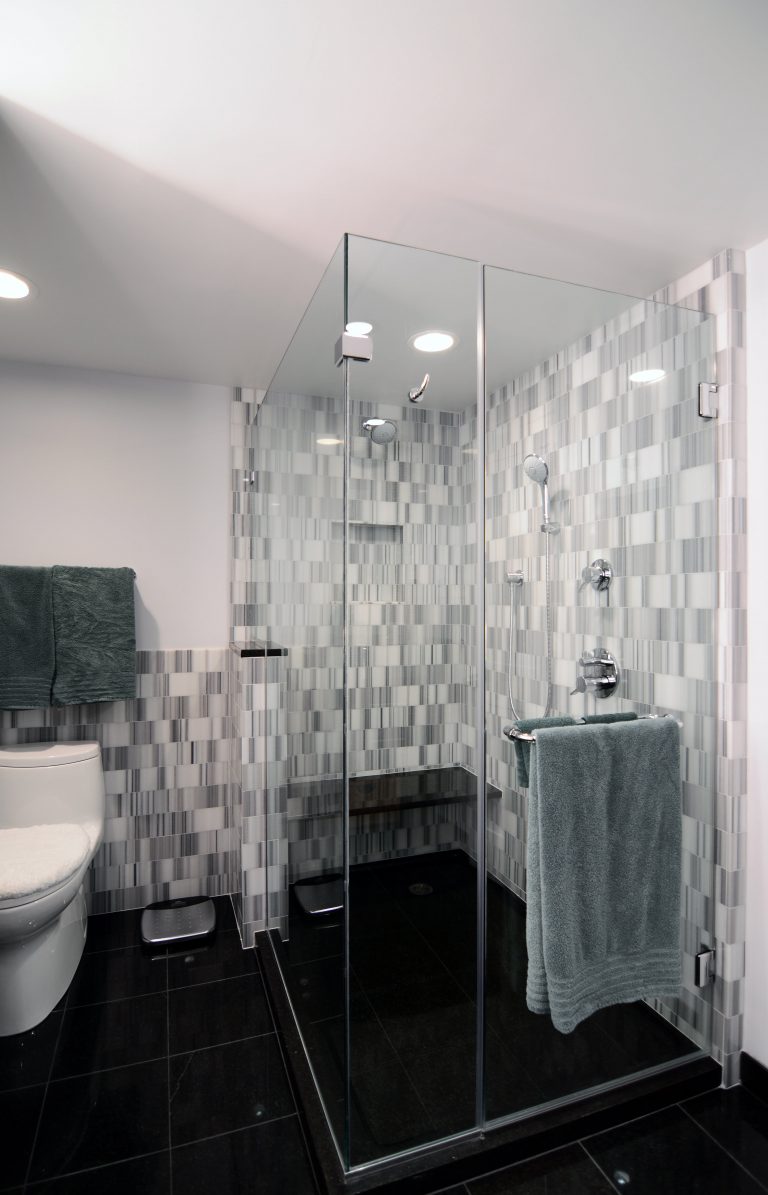 modern bathroom in dc condo contrasting colors large shower stall with glass walls and built in bench