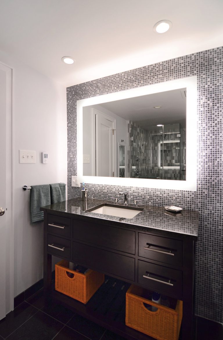 modern dc condo bathroom dark wood vanity backlit mirror tiled feature wall