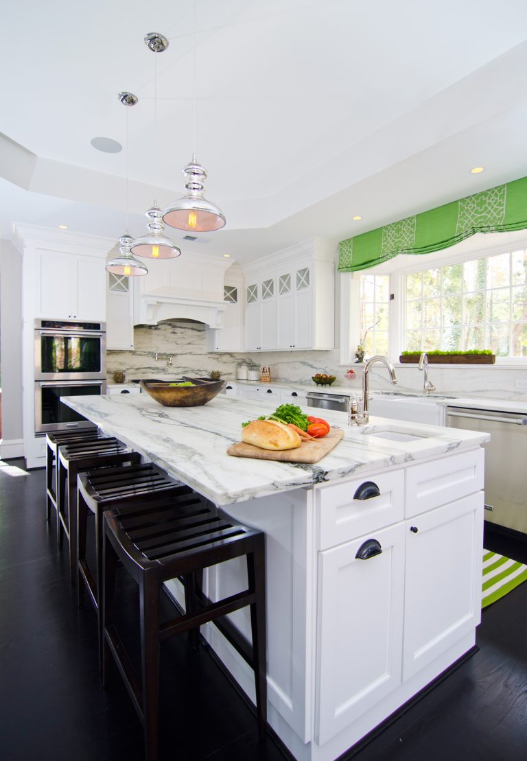 bright white kitchen with center island and bar seating