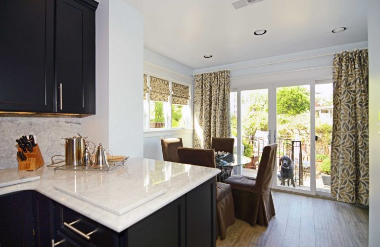 DC home modern kitchen remodel black cabinetry white countertops contrast peninsula flow into dining area