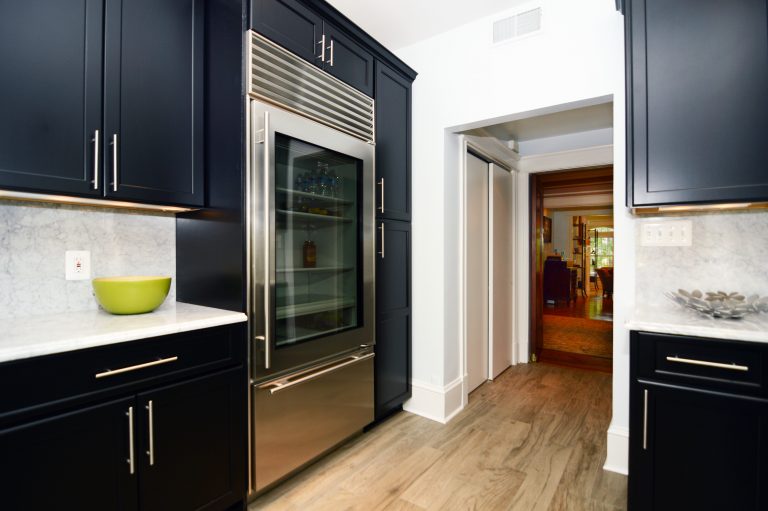 DC home modern kitchen remodel black cabinetry contrast wood floors large refrigerator