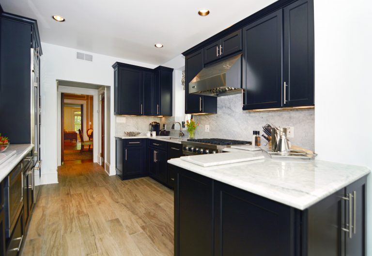 DC home modern kitchen remodel black cabinets contrast white countertops wood floors peninsula
