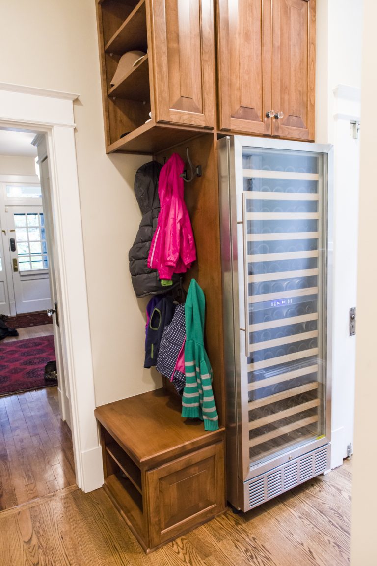 mudroom entry with built-in cubby area and tall beverage refrigerator