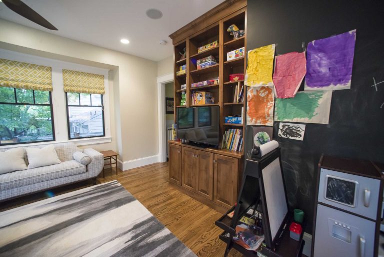 living area with built-in entertainment center and chalkboard wall