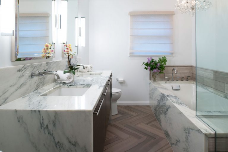 bathroom remodel separate tub waterfall edge countertops wall mounted faucet mixed textures neutral colors elegant style