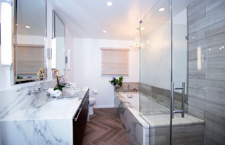 mixed materials bathroom remodel waterfall edge counters separate tub and shower stall with glass door