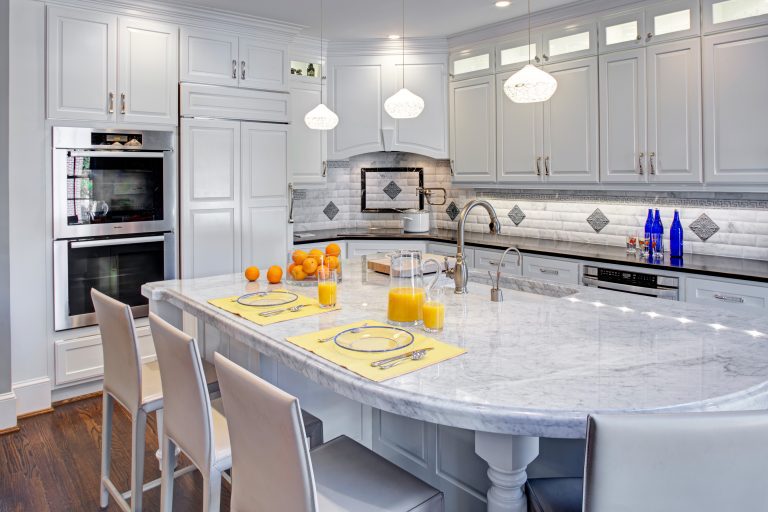 bright white kitchen double wall oven pendant lighting over large island