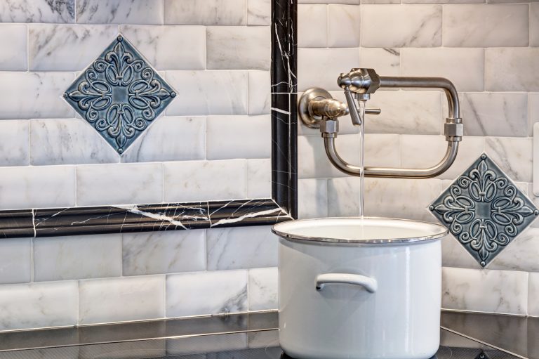 potfiller and tile backsplash detail behind stovetop