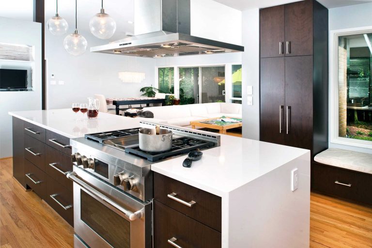 modern kitchen stainless steel appliances dark wood island with waterfall edge countertops