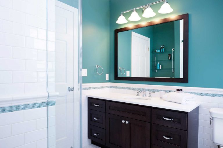 dark cabinet vanity lots of counter space teal color palette