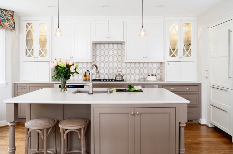 bright kitchen with neutral color palette island with seating and pendant lighting geometric backsplash