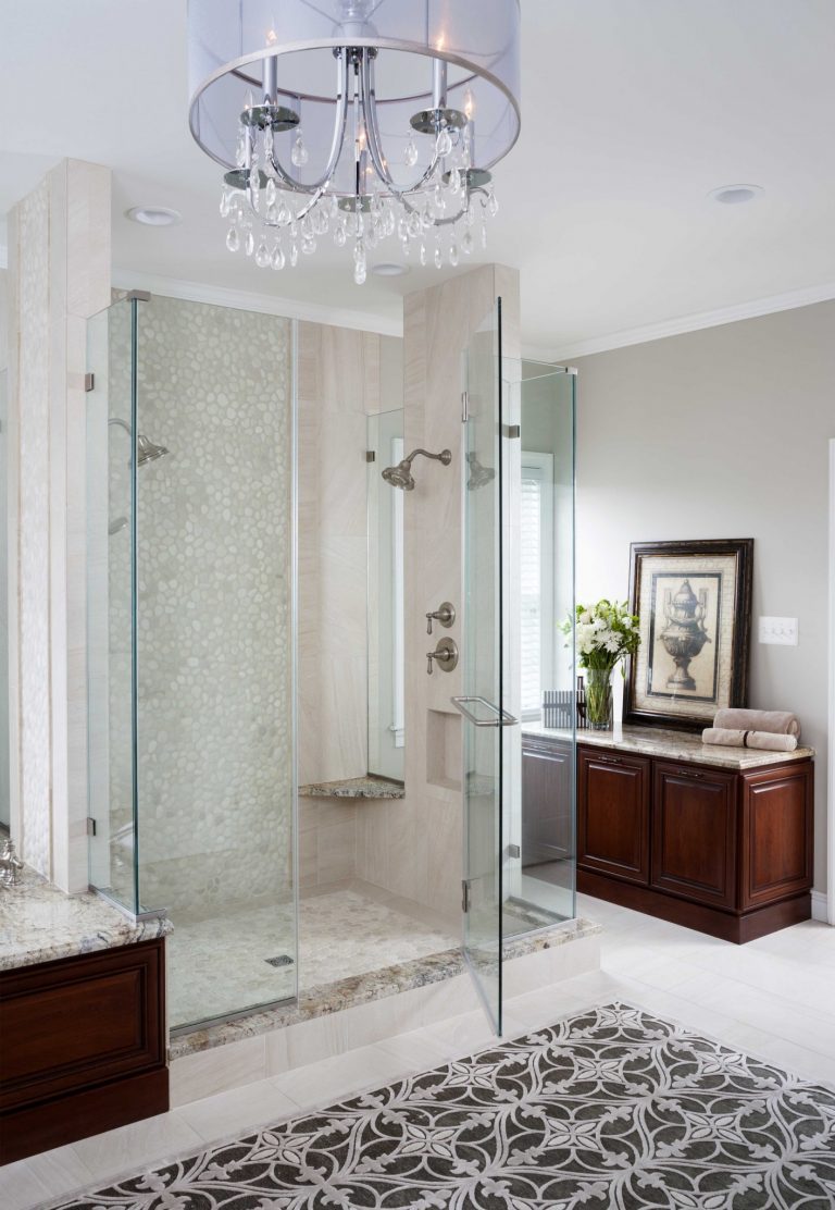 master bathroom glass shower stall chandelier and tile floor feature