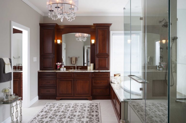 elegant master bathroom separate wood panel tub dark wood vanity chandelier floor tile feature