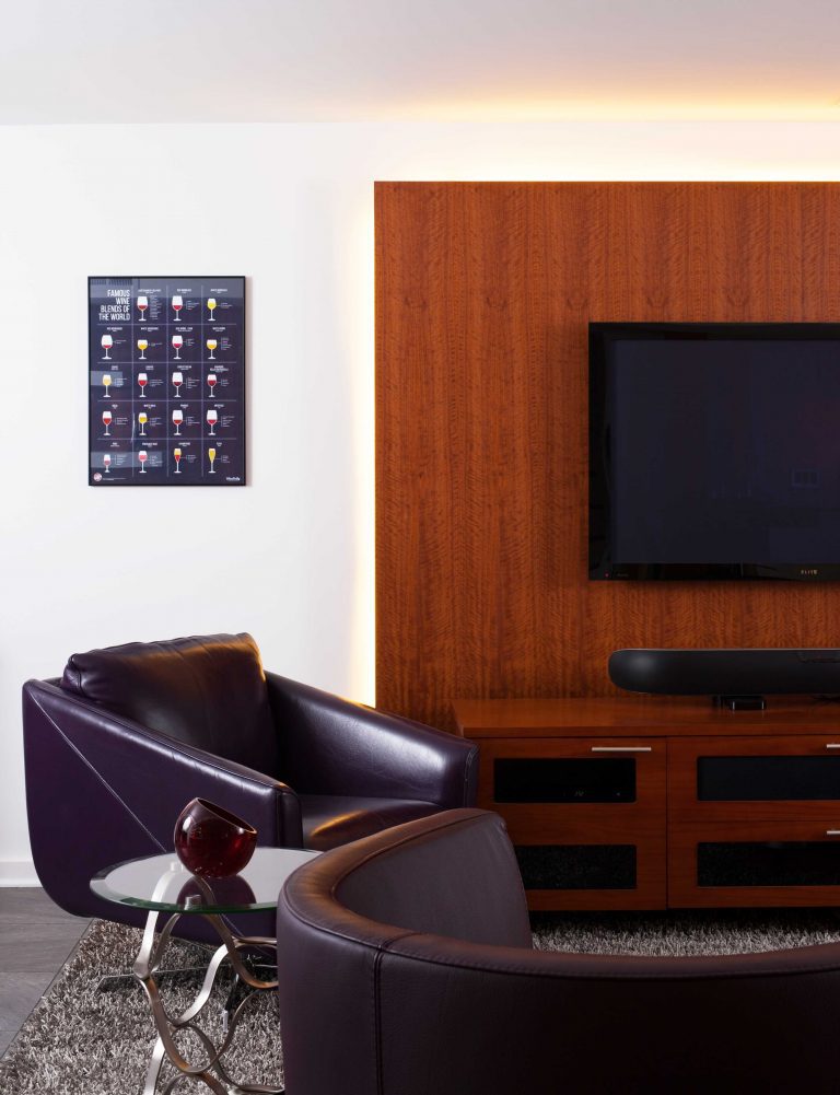 modern style built in entertainment area natural wood wall feature and wall mount tv leather chairs