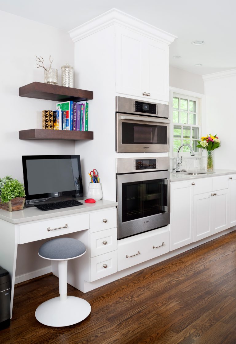 built in desk area in kitchen with open shelving