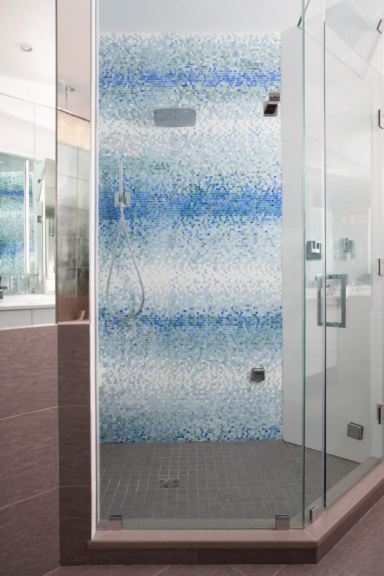 modern bathroom shower stall with glass door and blue mosaic tiling