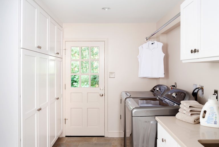 renovated mudroom and laundry room bright white cabinetry for plenty of storage