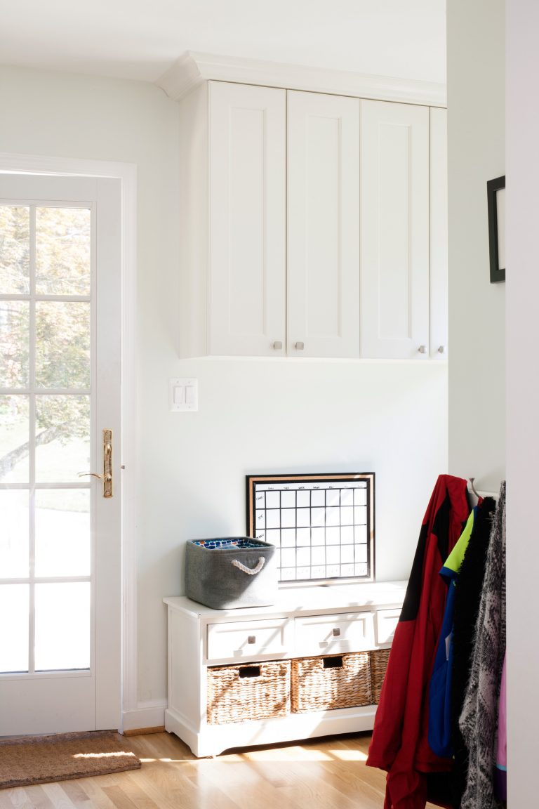 mudroom entry area glass doors white cabinetry for storage