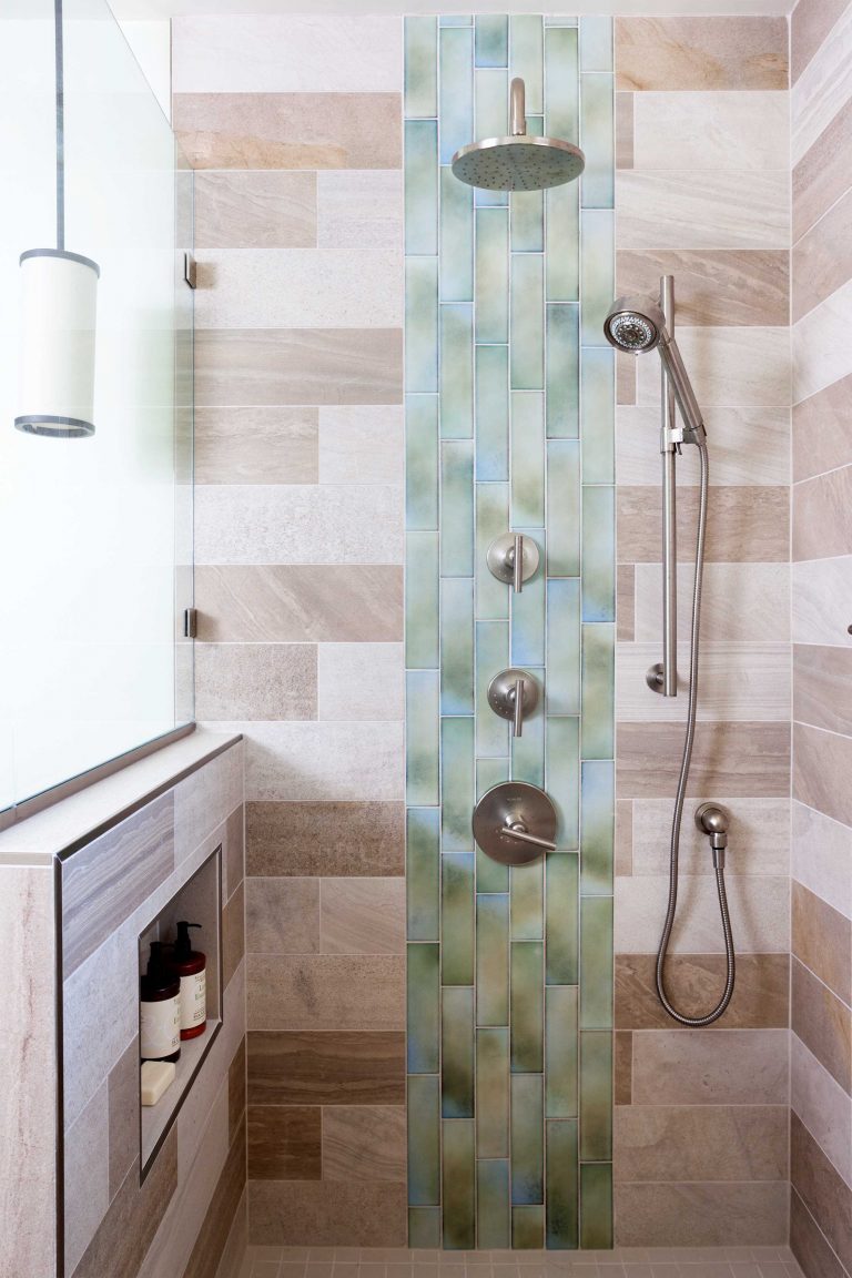 rain waterfall shower head natural color palette modern bathroom tile contrast storage nook