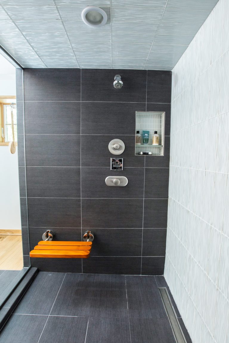 large modern shower white and dark gray tiles waterfall rain showerhead and built-in bench