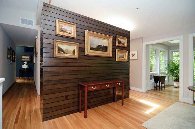 dark wood paneled feature wall to define spaces