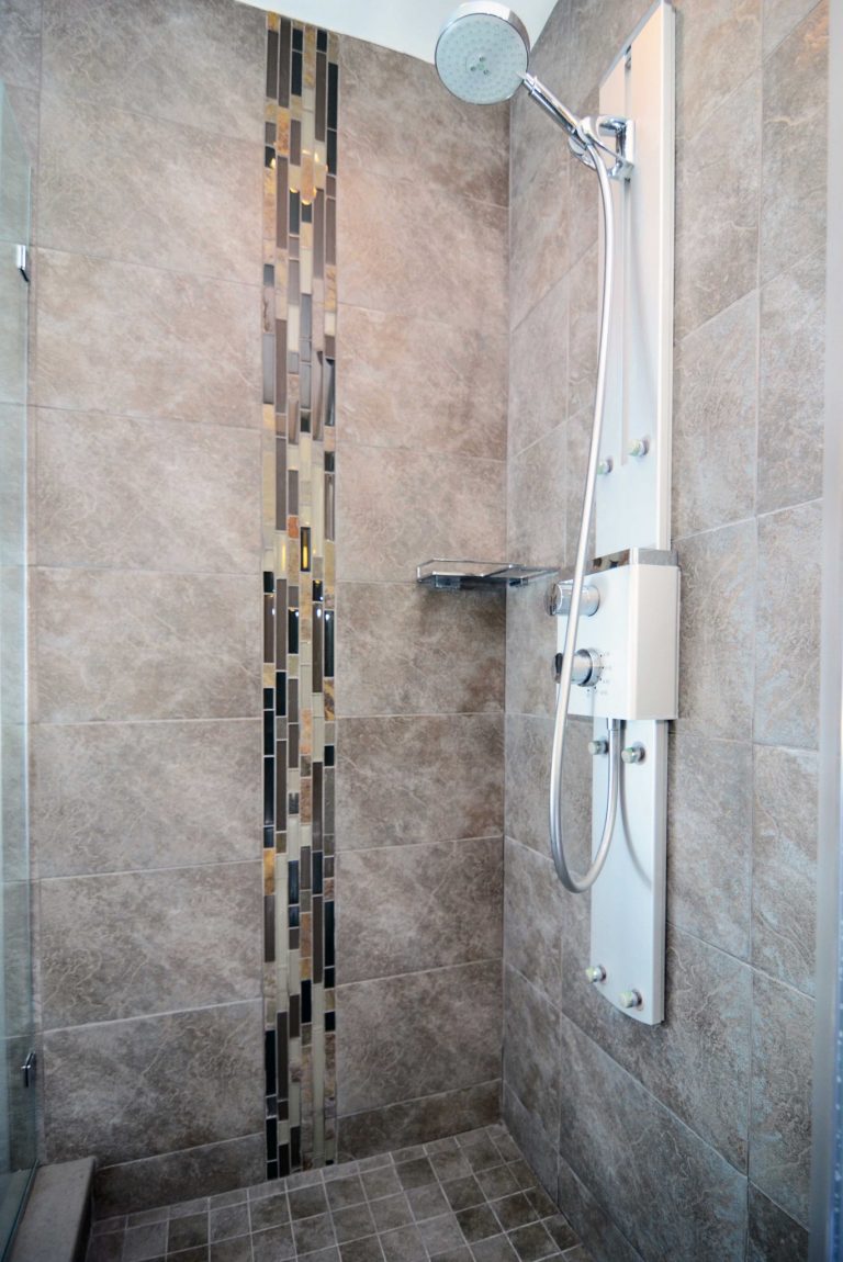 renovated shower stall grey color palette with tile feature