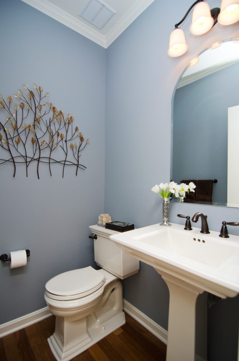 renovated powder room wood floors soft blue walls