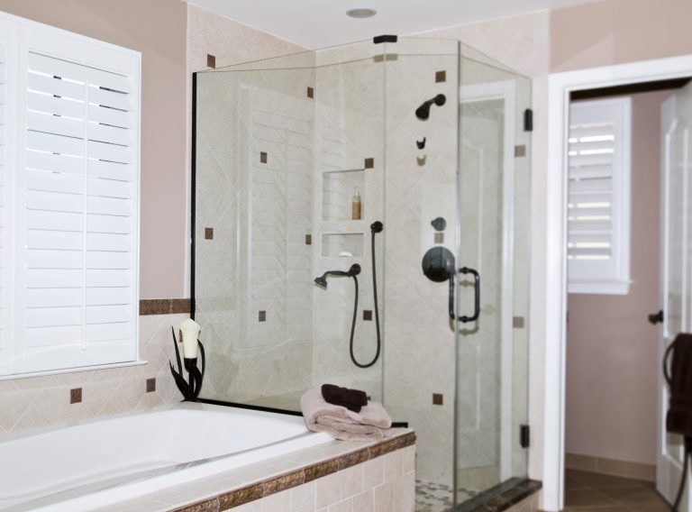 neutral color palette bathroom separate tub and shower stall with glass door