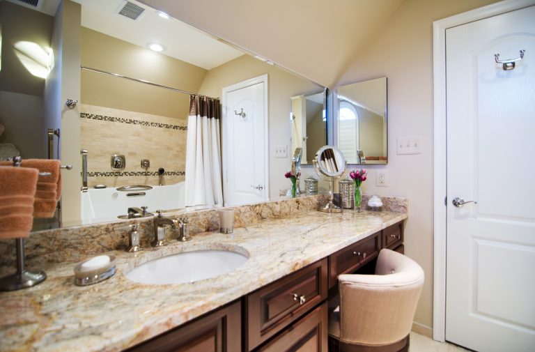 renovated bathroom neutral and warm color palette with makeup area