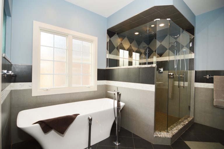 modern bathroom geometric tile black and white separate tub and shower stall with glass doors