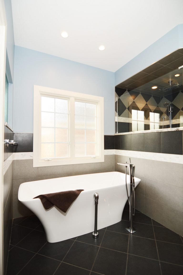 modern bathroom freestanding tub geometric diamond tile black white and blue color scheme