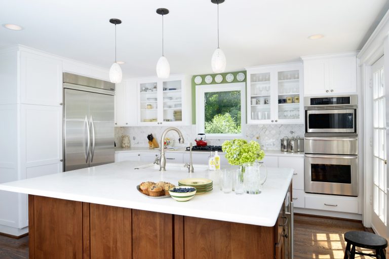 white cabinet kitchen contrast medium stain center island with sink and pendant lighting