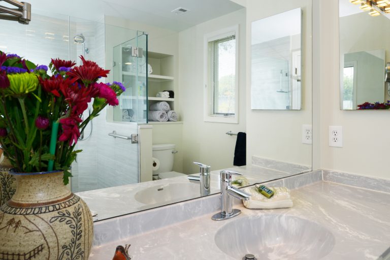 sink and vanity in modern bathroom remodel gray countertops chrome fixtures