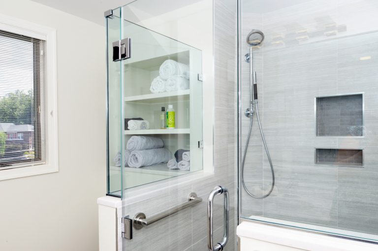 modern bathroom remodel gray color palette open shelving storage separate shower stall with glass door and storage nook