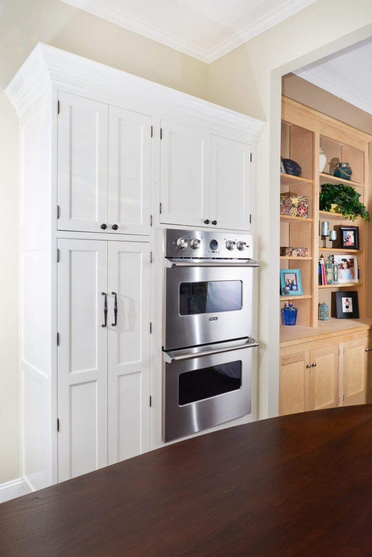 white cabinet pantry with stainless steel double wall oven