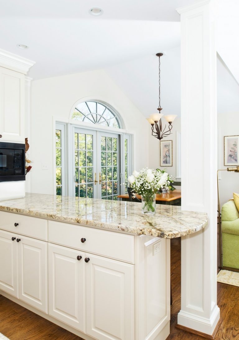 bright kitchen white cabinet peninsula with granite counter tops french doors