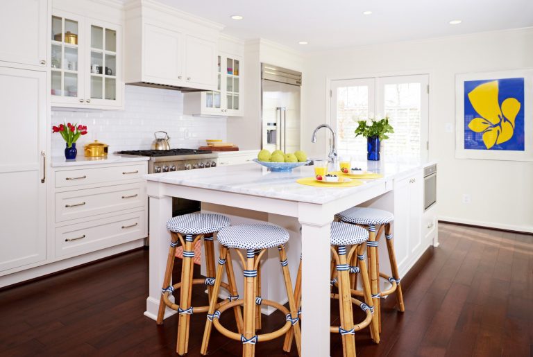 bright white kitchen with dark wood floors island with seating glass door upper cabinets