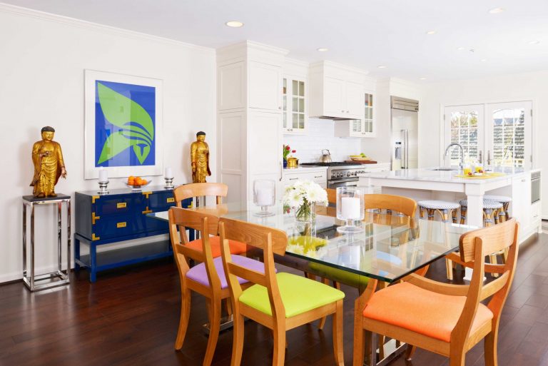 colorful eat in area with glass dining table bright white kitchen dark wood floors