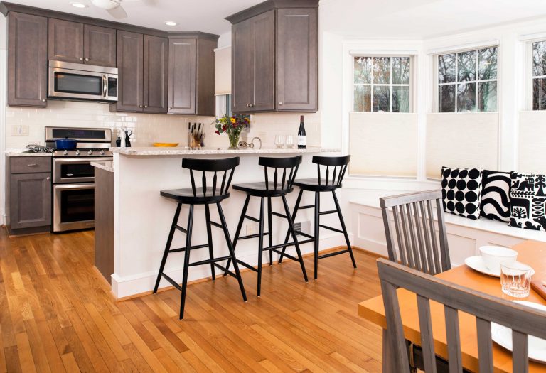 traditional craftsman kitchen in dc home grey stained wood cabinetry and bar seating flows into dining area