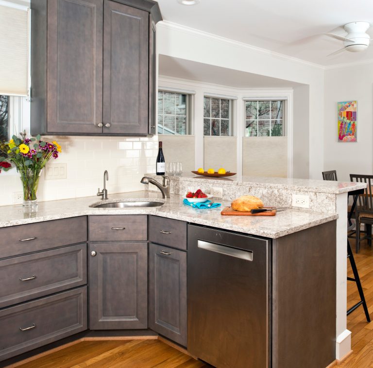 grey stained wood cabinetry in craftsman style kitchen lots of light