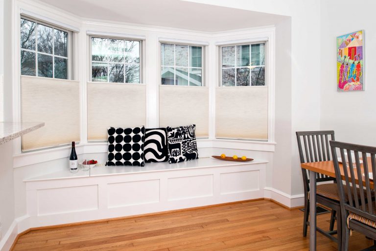 large bay windows with built in bench in dining area