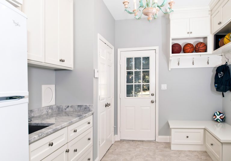 mudroom addition in maryland home soft color palette storage benches and hooks spare refrigerator and sink area