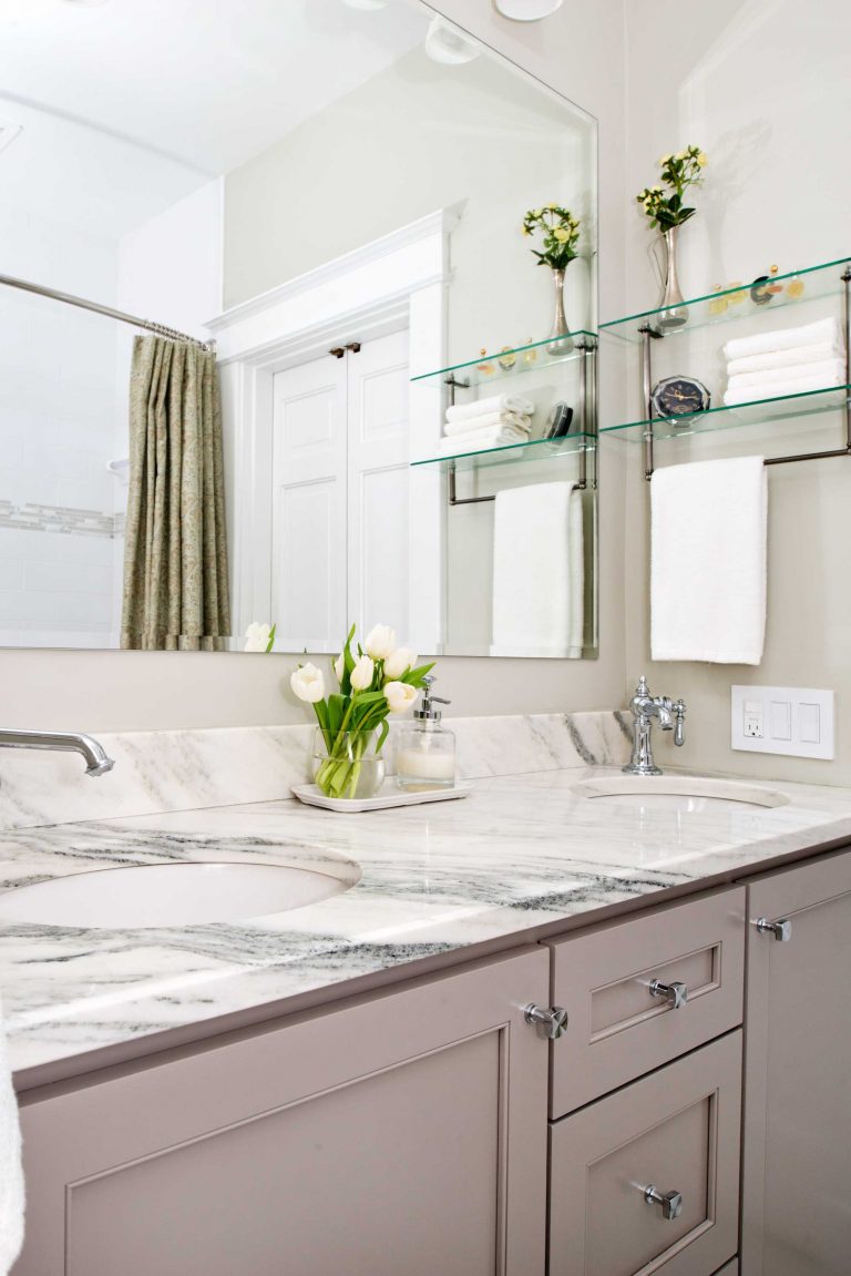 elegant bathroom in dc townhouse neutral color palette grey cabinetry marble countertops glass shelves