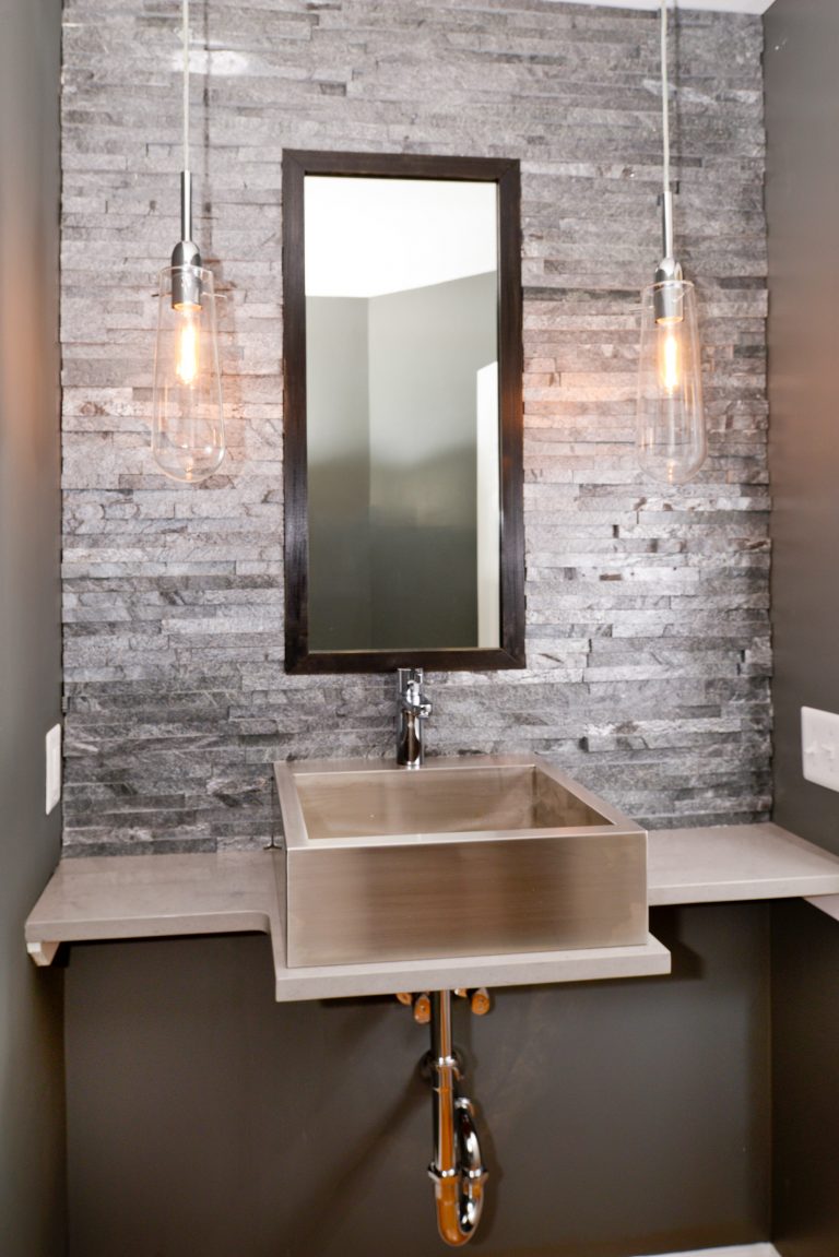 industrial powder room metal sink exposed pipes stone backsplash