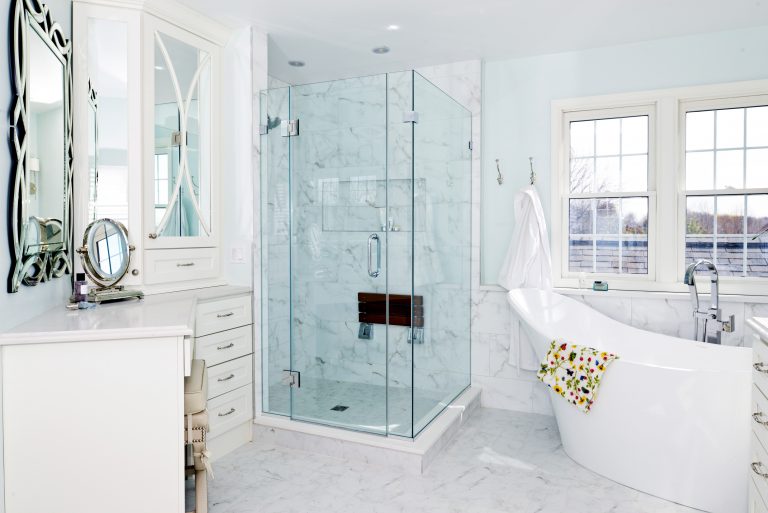 freestanding tub separate shower stall with glass doors and mosaic tile detail cabinets for storage built in vanity blue color palette