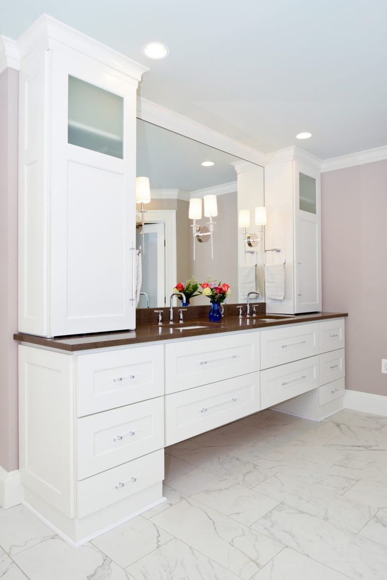 modern bathroom renovation pink and neutral color palette double sink vanity white cabinetry brown countertops plenty of storage